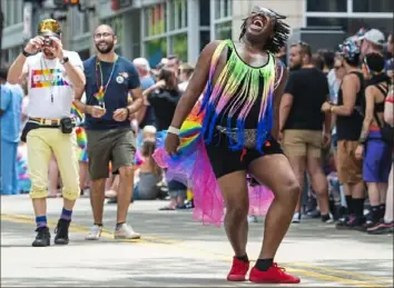  ?? Caitlin Lee/Post-Gazette ?? A parade participan­t dances as he walks in the Pittsburgh Pride Equality March Downtown in 2019.