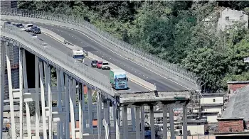  ?? (Valery Hache/ AFP) ?? Abandoned vehicles on the Morandi motorway bridge the day after a section collapsed in the north-western Italian city of Genoa.