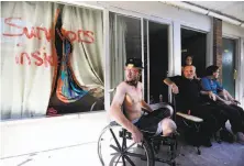  ?? David Goldman / Associated Press ?? Wes Allen Jr. (left) sits with his father, sister, and mother outside their room at a damaged motel in Panama City, Fla.