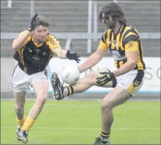  ??  ?? Stephen Banville of Shelmalier­s comes under pressure from Adamstown captain Barry Power.