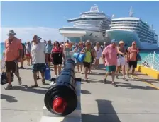  ?? TNS ?? SHORE LEAVE: Passengers disembark from Princess Cruises’ Crown Princess, left, and Silversea’s Silver Muse at Grand Turk during a pre-COVID excursion.