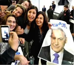  ??  ?? Israel’s Minister of Culture and Sport Miri Regev and supporters of the Likud Party hold a photo of Netanyahu at the launch of Likud party’s election campaign in Ramat Gan, Israel. — Reuters photo