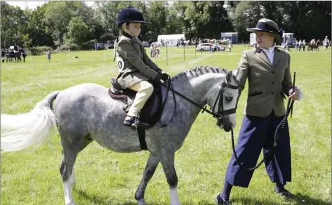  ??  ?? Pictured at the Kilmacanog­ue Horse Show at Monastery Cross was Kayla Luby riding ‘Windleshaw Mario’ led by Ciara Luby, warming up for the 3-5 Lead Rein event.