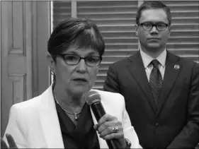  ??  ?? Kansas Gov. Laura Kelly answers questions from reporters after signing her executive order aimed at ending an economic “border war” between her state and Missouri over jobs in the Kansas City area, on Friday, at the Statehouse in Topeka, Kansas. AP PHOTO/JOHN HANNA