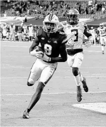  ?? MICHAEL LAUGHLIN/SUN SENTINEL ?? Miami receiver Dee Wiggins runs into the end zone during the Hurricanes’ win over Florida State on Saturday night in Coral Gables.