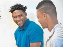  ?? JIM RASSOL/SUN SENTINEL ?? Marlins players Jorge Guzman laughs with teammate Jose Devers during an English language class held at the Marlins training facility.