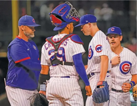  ?? GETTY IMAGES ?? Cubs manager David Ross takes the ball from starter Keegan Thompson in the second inning Thursday against the Pirates at Wrigley Field.