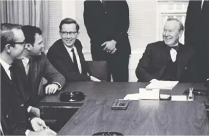  ??  ?? This photo shows writer Ian Smillie, far left, meeting former prime minister Lester Pearson, right.