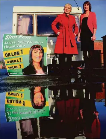  ?? AFP ?? Sinn Fein’s new Northern leader, Michelle O’Neill (left) and Sinn Fein candidate Linda Dillon, pose for a photograph as they leave after casting votes in Clonoe, near Coalisland yesterday.