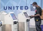  ?? PHOTO: DAVID PAUL MORRIS/ BLOOMBERG ?? Passenger slump: A traveller uses a United Airlines kiosk at San Francisco Internatio­nal Airport