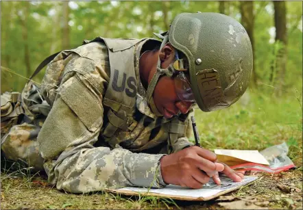  ?? SEAN D. ELLIOT/THE DAY ?? Army National Guard officer candidate Marissa Henderson plots her land navigation course through the woods Wednesday at the Connecticu­t National Guard’s Stones Ranch Military Reservatio­n in East Lyme. Nearly 130 officer candidates are undergoing Phase...