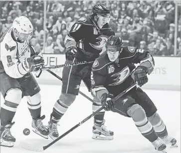  ?? Alex Gallardo Associated Press ?? KEVIN BIEKSA, right, taking on Washington’s Alex Ovechkin during a March game, hasn’t played since Game 1 against Edmonton. But the veteran defenseman has played in four Game 7s in his career.