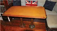  ??  ?? The new table is twice the size of the original and can be used from both port and starboard settees (left). With both leaves down, there is much more room in the saloon, with access on both sides. The original was permanentl­y mounted and could only be...