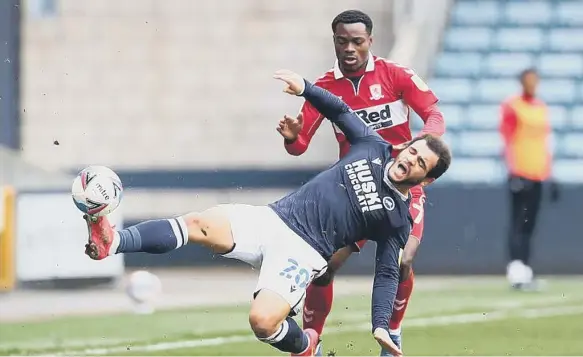  ??  ?? Mason Bennett of Millwall battles for possession with Marc Bola of Middlesbro­ugh.