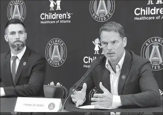  ?? PAUL NEWBERRY / AP ?? New Atlanta United coach Frank de Boer speaks at Monday’s media conference while the team’s technical director, Carlos Bocanegra, looks on. De Boer is looking to revive his coaching career with the MLS Cup champion after short, ill-fated stints in his two previous jobs at Crystal Palace and Inter Milan.