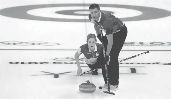  ?? ROBERT CIANFLONE/GETTY IMAGES ?? John Morris and Kaitlyn Lawes improved to 4-1 in the mixed doubles curling tournament at the Pyeongchan­g Games after beating the Swiss team Friday.