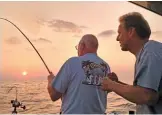  ?? DALE BOWMAN/SUN-TIMES ?? Andy Mikos (right) pleads for a Chinook at dawn on a late-summer outing in a file photo.