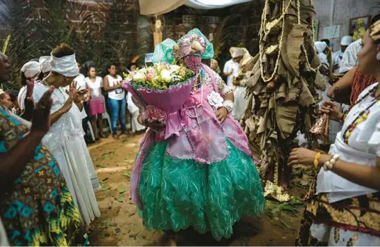  ?? RODRIGO ABD/AP ?? Members of the Afro-Brazilian faith Candomble dance during a ritual Sept. 18 outside Salvador, Brazil. Incidents of religious intoleranc­e against them are on the rise.