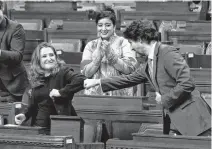  ?? BLAIR GABLE • REUTERS ?? Federal Finance Minister Chrystia Freeland receives a fistbump from Prime Minister Justin Trudeau after unveiling her first fiscal update, the Fall Economic Statement 2020, in the House of Commons on Monday.