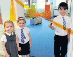  ??  ?? Grand reveal Sean Paul Baird, eight, cuts the ribbon, while five-year-olds Islay MacDonald and Eva Crawford look on