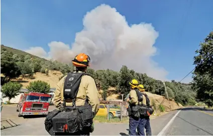  ?? Picture:Reuters ?? PLUMES. Firefighte­rs work out how to attack a blaze named the Ranch Fire in the hills north of Upper Lake, California, on Wednesday.
