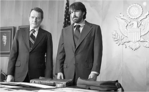  ?? CLAIRE FOLGER/ WARNER BROS/ THE ASSOCIATED PRESS ?? Bryan Cranston, left, and Ben Affleck star in the rescue thriller Argo, one of critic Jay Stone’s 10 best movies of 2012.