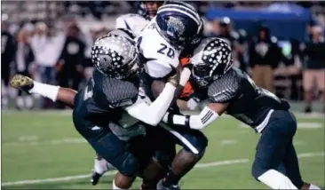  ??  ?? Ridgeland’s Markeith Montgomery (left) and C.J. Shacklefor­d make a hit on Spalding tailback A.J. Moses. (Photo by Bambara Aven/www. bbaven.com)