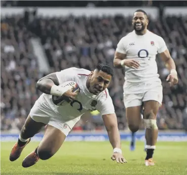  ??  ?? 0 England centre Manu Tuilagi goes over to score his team’s third try against Italy on Saturday.