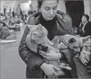  ?? Marcus Yam/los Angeles Times/tns ?? Julia Gereasumen­ko and her pets, Garfield the cat and Yoda the dog, take shelter undergroun­d in a subway station on the seventh day of the Russian invasion, in Kyiv, Ukraine, on March 2.