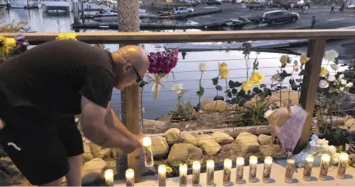  ?? | AP ?? Orlando Aldana lights 34 candles at the growing memorial in Santa Barbara which he bought in honour of the victims on The Conception.