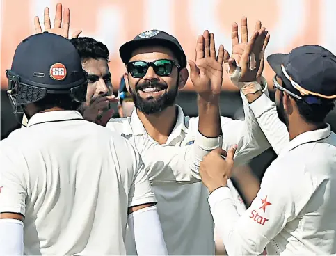  ??  ?? On top of the world: India captain Virat Kohli (centre), whose side are No 1 in the ICC rankings, celebrates in Indore during the series victory over New Zealand in October