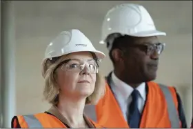  ?? (AP/Stefan Rousseau) ?? British Prime Minister Liz Truss (left) and Chancellor of the Exchequer Kwasi Kwarteng visit a constructi­on site for a medical innovation campus Tuesday in Birmingham, during day three of the Conservati­ve Party annual conference at the Internatio­nal Convention Centre in Birmingham, England.