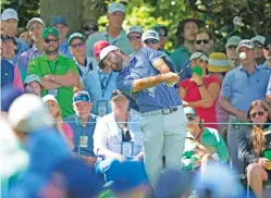  ?? MATT SLOCUM/THE ASSOCIATED PRESS ?? Scottie Scheffler hits his tee shot on the seventh hole Friday at the Masters in Augusta, Ga. He shared the lead with two others.