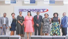  ?? ?? Econet COO, Mr Kezito Makuni, (fourth from right), stands inside the new-look Econet shop with ZITF’s deputy CEO Ms Stella Nkomo (fourth from left) who was guest of honour at the opening ceremony on Friday. Also in the picture are senior Econet staff who attended the event