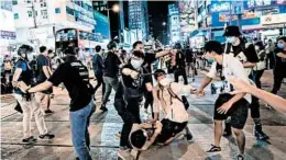  ?? BILLY H.C. KWOK/GETTY ?? Undercover police arrest attendees during a memorial vigil Thursday night in the Mongkok district of Hong Kong. Crowds marked the 1989 Tiananmen Square protests.