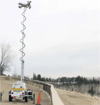  ?? LEAH HENNEL/ CALGARY HERALD ?? Cameras were installed next to the fence constructi­on project on the park ridge overlookin­g the Elbow River on Britannia Drive in an effort to reduce vandalism problems in the area.