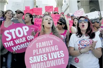  ?? NICK UT/THE ASSOCIATED PRESS FILES ?? In this Sept. 9, 2015 file photo, Planned Parenthood supporters rally for women’s access to reproducti­ve health care on National Pink Out Day’ at Los Angeles City Hall. U.S. President Donald Trump is allowing more employers to opt out of providing...