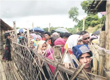  ??  ?? File photo shows Rohingya refugees queuing at an aid relief distributi­on centre at the Balukhali refugee camp near Cox’s Bazar. — AFP photo