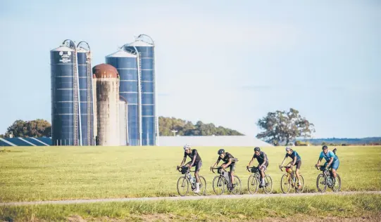  ?? JOEL CALDWELL ?? Bicyclists, including John Shackelfor­d, second from left, cycle through rural Georgia, visiting places associated with Black history as they ride from Mobile, Alabama, to Washington, D.C.