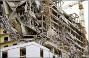  ?? SCOTT THRELKELD—ASSOCIATED PRESS ?? Debris hangs on the side of the building after a large portion of a hotel under constructi­on suddenly collapsed in New Orleans on Saturday, Oct. 12, 2019. Several constructi­on workers had to run to safety as the Hard Rock Hotel, which has been under constructi­on for the last several months, came crashing down. It was not immediatel­y clear what caused the collapse or if anyone was injured.