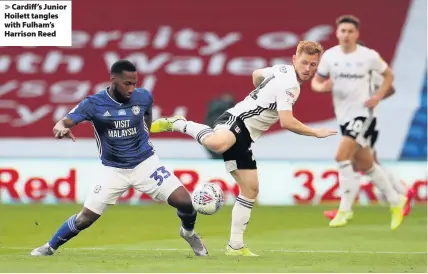  ??  ?? > Cardiff’s Junior Hoilett tangles with Fulham’s Harrison Reed