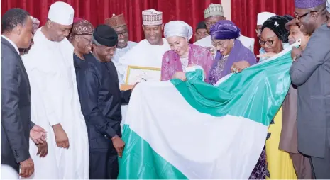  ?? Photo: Felix Onigbinde. ?? Acting President Yemi Osinbajo (middle), flanked by Senate President Bukola Saraki; and other Ministers, presents Nigerian flag to the former Minister of Environmen­t and the new Deputy Secretary General of the United Nations, Mrs Amina Mohammed during...
