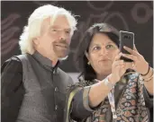  ?? — PTI ?? CII presdient Shobana Kamineni takes a selfie with founder of Virgin Group Richard Branson during the opening ceremony of the Magnetic Maharashtr­a Convergenc­e 2018 in Mumbai on Sunday.