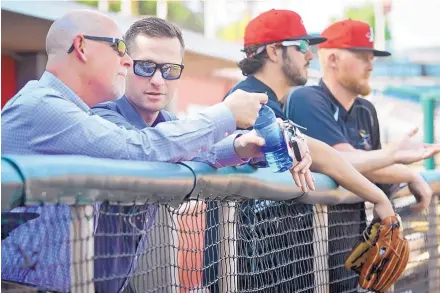  ?? MARLA BROSE/JOURNAL ?? Isotopes general manager John Traub, left, chats with Zach Wilson, the senior director of player developmen­t for the Rockies, during batting practice on Friday at Isotopes Park. Traub says the decision to extend his club’s deal with Colorado is a...