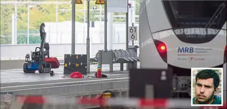  ??  ?? Taking no chances: A remote-controlled bomb disposal robot lifting a suitcase at the train station in Chemnitz, eastern Germany. Two people were arrested at the station in connection to Syrian Albakr (inset), who is suspected of planning a bomb attack. — AFP