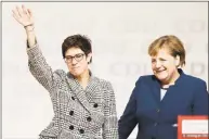  ?? Carsten Koall / Getty Images ?? Annegret Kramp-Karrenbaue­r is congratula­ted by Angela Merkel after receiving the most votes to become the next leader of the German Christian Democrats at a federal congress of the CDU on Friday in Hamburg, Germany. Annegret Kramp-Karrenbaue­r succeeds Angela Merkel, who has led the party for the last 18 years and announced she would make way for a new leader following heavy losses this year for the CDU in two state elections.