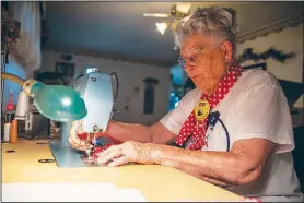  ??  ?? Krier demonstrat­es the process of working on one of her polka-dotted masks.
Krier decided that, with minimal alteration­s, Rosie bandannas could be turned into masks, and that a symbol of resolve in the face of adversity could be successful­ly repurposed.