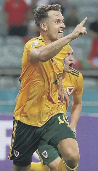  ??  ?? 0 Wales midfielder Aaron Ramsey celebrates after scoring his opening goal