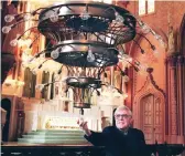  ?? SUN-TIMES FILE ?? The Rev. George Lane in 1998 looks at new light fixtures at Holy Family Church, 1080 W. Roosevelt Road.