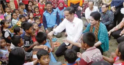  ??  ?? BALI: Indonesian President Joko Widodo, center, and his wife Iriana, right, are greeted by children during their visit at a temporary shelter for villagers who were evacuated from their homes on the slope of Mount Agung in Karangasem, Bali, Indonesia....